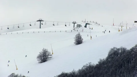 Cloudy day on ski slopes with skiers Stock-Footage 85758020
