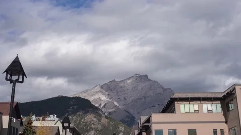 Cloudy day sky. fluffy clouds moving fast above high mountain. timelapse clou Stock Footage 166930826