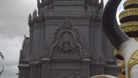 Cloudy day temple wall carvings sculptures move left Stock Footage 228960562