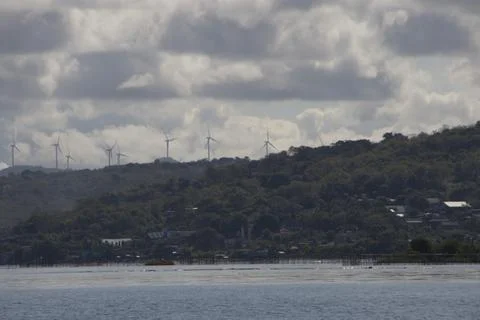 A cloudy day with a view of a wind farm Stock Photos