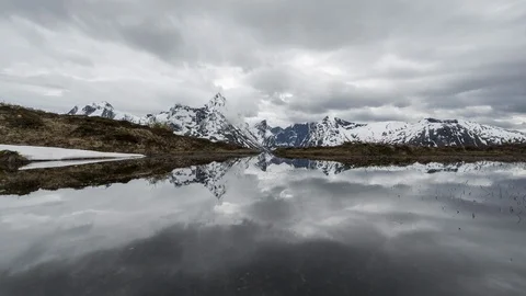 Cloudy day in the wild with mountain mirroring in the lake Stock Footage 122972857