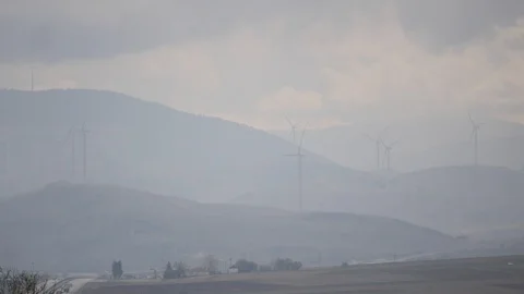 Cloudy day in a windmill farm in the mountain Stock Footage 100543944