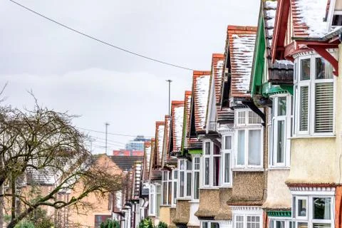 Cloudy Day Winter View of Row of Typical English Terraced Houses under snow in Photos