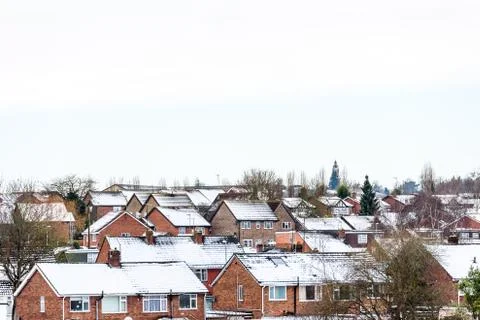 Cloudy Day Winter View of Row of Typical English Terraced Houses under snow in 写真素材