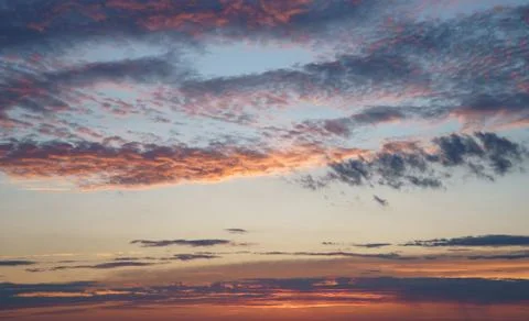 Cloudy dramatic blue and orange skies early morinnig at sunrise Stock Photos