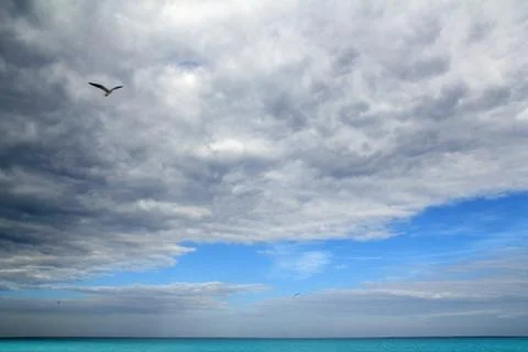 Cloudy dramatic sky in caribbean turquoise sea Stock Photos