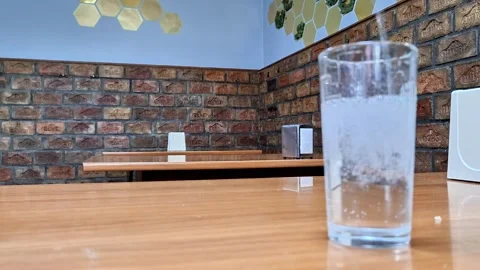 Cloudy Drink in a Glass on Wooden Table Inside Cozy Rustic Cafe Vídeo Stock 338045502