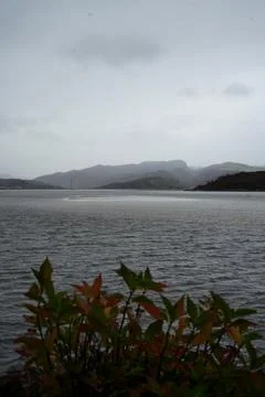 Cloudy Estuary View With Distant Hills And Power Lines Near Portmeirion, North Stock Photos