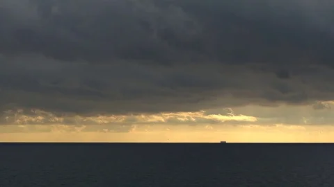 Cloudy evening at the seaside with a large ship far away over the horizon Video stock 73178230