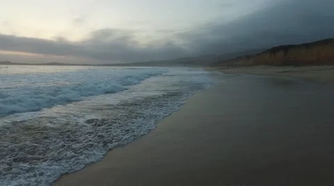 Cloudy evening shore slow fly-over Video stock 64366218
