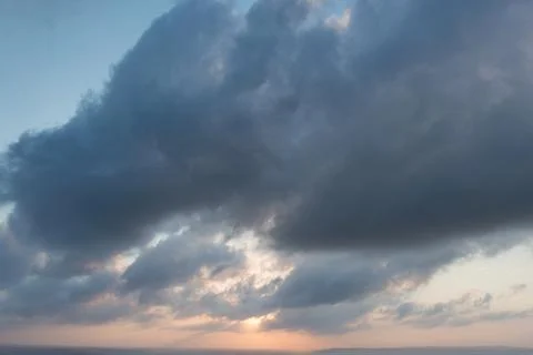 Cloudy evening sky. Sunset. Sun low over the horizon Fotos Stock