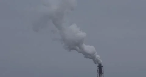 On a cloudy gray day, smoke comes from the chimneys of the plant. Stock Footage 156522178