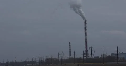 On a cloudy gray day, smoke comes from the chimneys of the plant. Stock Footage 156522184
