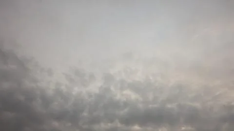 A cloudy gray sky with a gradient of light gray at the top. The lower part .. Stock Photos