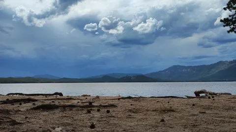 Cloudy gray sky, rainy weather. Shore of the lake, sand. Summer nature. Stock Footage 287014372