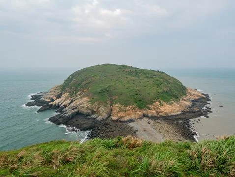 Cloudy high angle view of the Clam Island Stock Photos