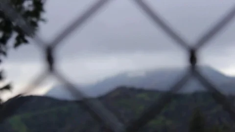 Cloudy Hollywood Sign Seen Through Wire Fence Stock Footage