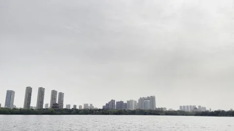 Cloudy Lakefront City Skyline 03 in China 4K Stock Footage 346220893