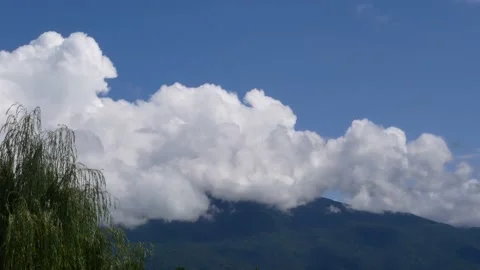 Cloudy landscape over green mountains on a sunny summer day. Stock Footage 227097654