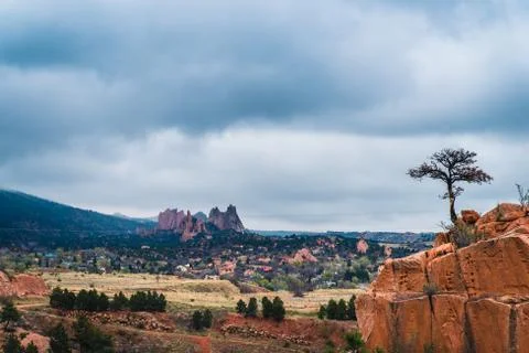 Cloudy landscape with red rock formations. Stock Photos