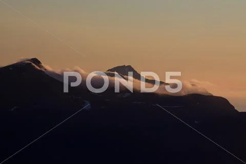 Cloudy mountain peaks Stock Photos