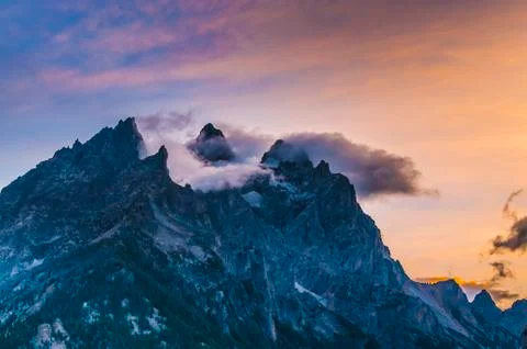 Cloudy mountain peaks at sunset Stock Photos