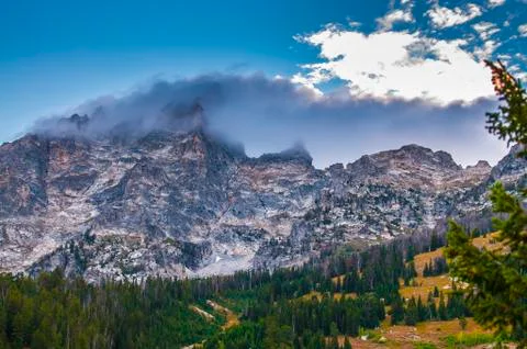 Cloudy mountain peaks at sunset Stock Photos