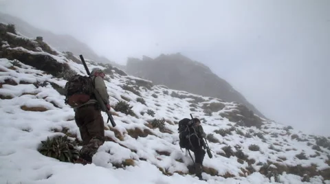 Cloudy mountain side with hunters. Stock Footage 49795987