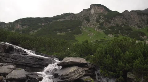 Cloudy Mountain Spring Water Flowing 4K Stock Footage 66561051