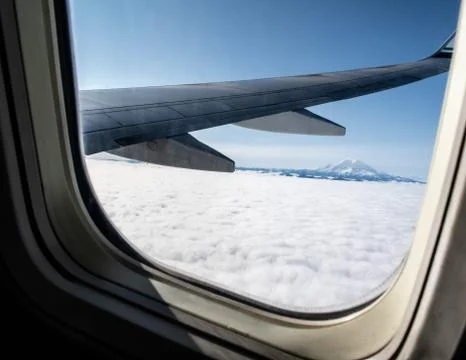 Cloudy mountain views from a plane Stock Photos