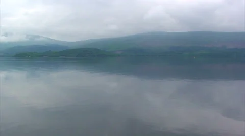 Cloudy mountains around a Scottish loch, pan right Stock Footage 39987540