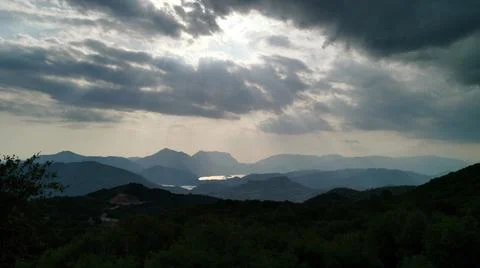 Cloudy mountains with green trees 写真素材