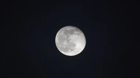 A cloudy night with nearly full moon view from a refractor telescope at near Zen Stock Footage 123196362