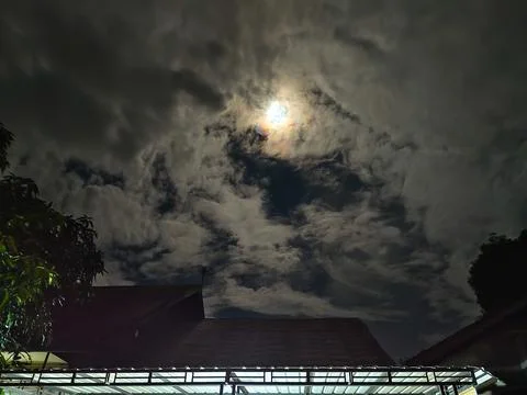 Cloudy night sky with moonlight Stock Photos