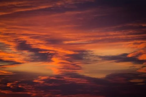 Cloudy orange sky in the sunset Stock Photos