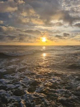 Cloudy over ocean sunset Stock Photos