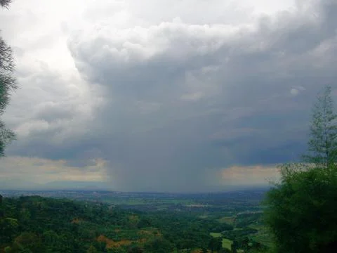 A cloudy raining in a far view Stock Photos