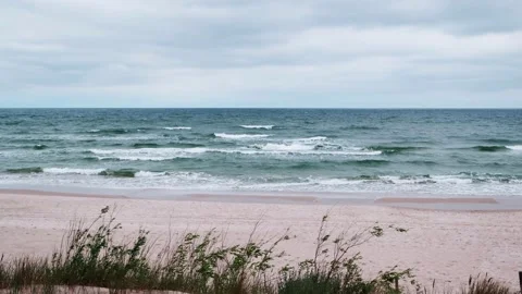 Cloudy rainy day at Baltic Sea. Beautiful sand beach with soft wave in sea water Stock Footage 133019032