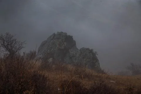 Cloudy rainy mountains. Rock's tom in fog. Stock Photos
