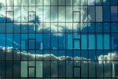 Cloudy reflections in the windows of the building. Stock Photos