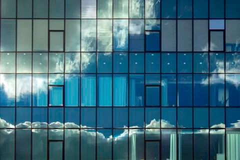 Cloudy reflections in the windows of the building. Stock Photos