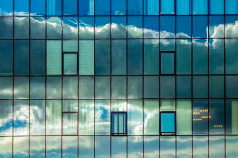 Cloudy reflections in the windows of the building. Stock Photos