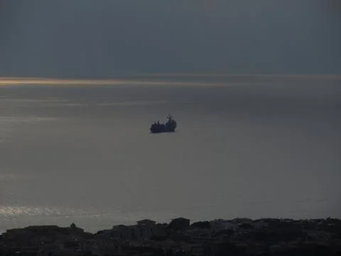 A cloudy sea and a setting sun Stock Photos