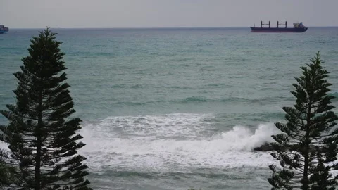Cloudy seascape, sea waves and container ships at horizon on Mediterranean coast Stock Footage 262005659