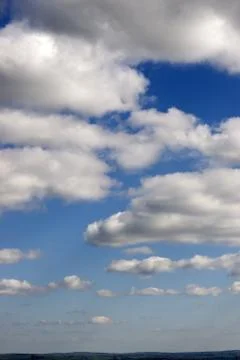 Cloudy sky above green fields Stock Photos