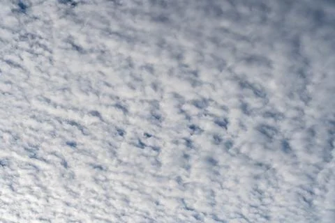 Cloudy sky abstract background with scattered white clouds Stock Photos