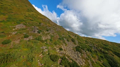 Cloudy sky. Aerial view going up by hill to the top of the mountain. Ukraine Stock Footage 186115459