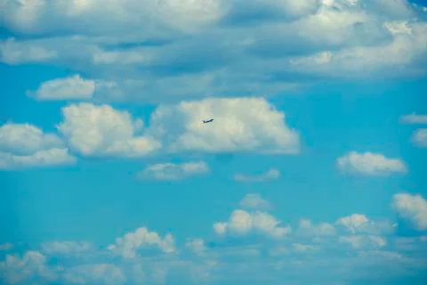 Cloudy sky with airplane Stock-Fotos