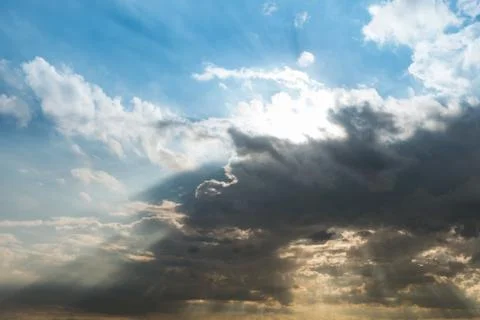 Cloudy sky and blue clear sky clouds and sunburst or sun beam at twilight bac Stock Photos