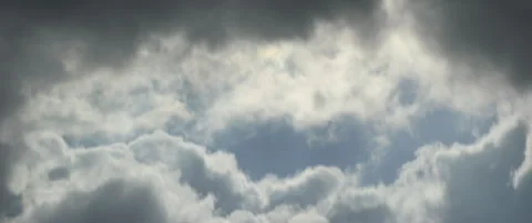 Cloudy sky and blue part in the middle 5.7K video Stock Footage 318975558